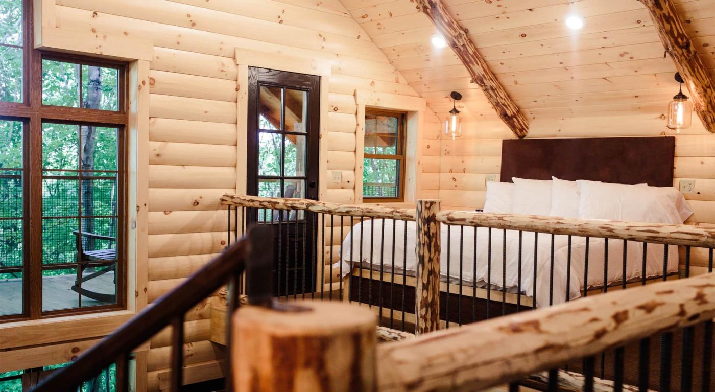 Loft bedroom in a log treehouse 