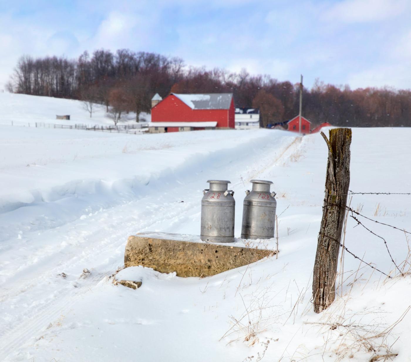 Milk canisters waiting to be picked up in Winter